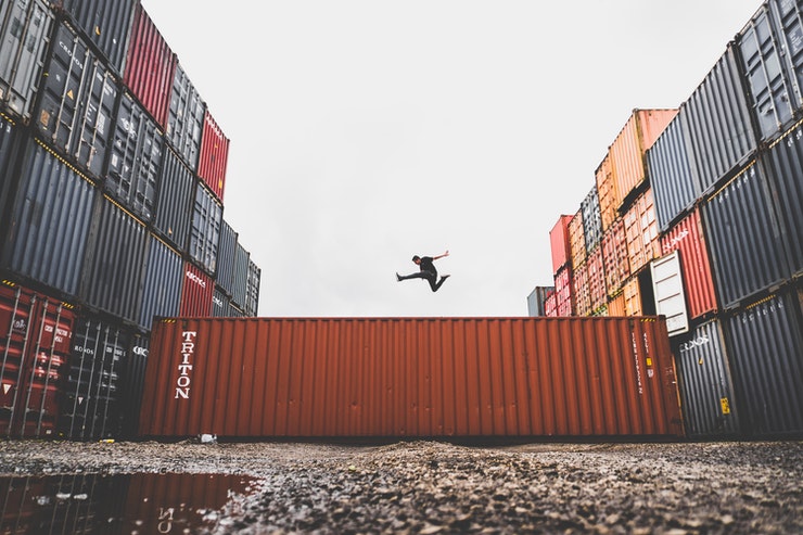 man jumping on container